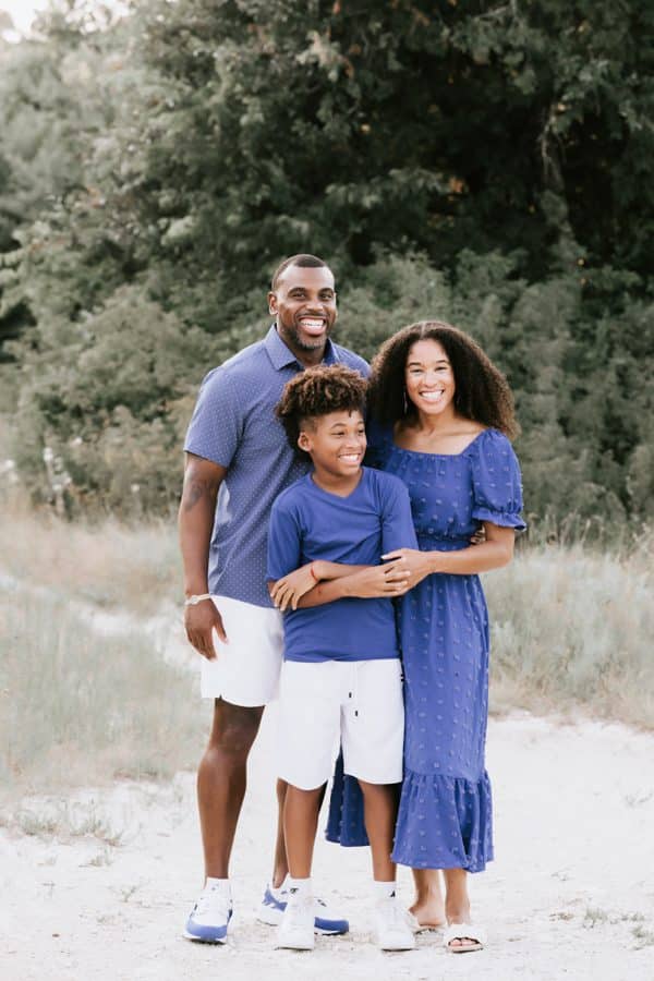 Spring Family Photo Session In Dallasof Family Of Three Smiling At Each Other
