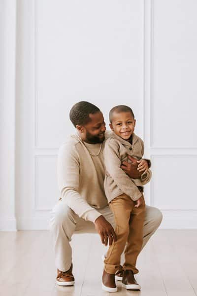 father looking at young son smiling for dallas family photographer
