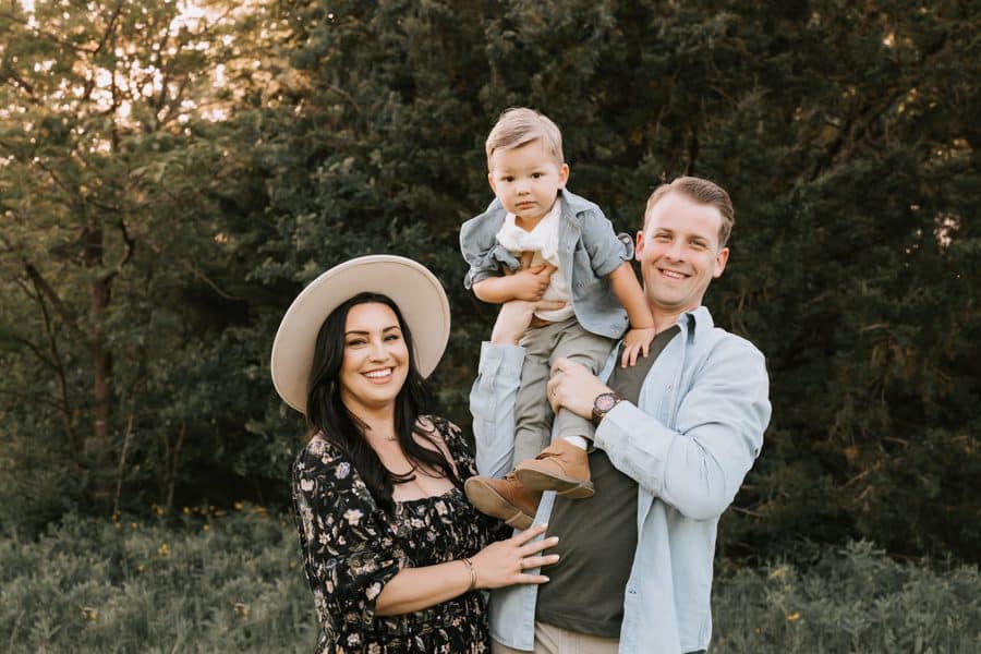 Dad Holding Son With Mom Smiling For A Beautiful Family Photos
