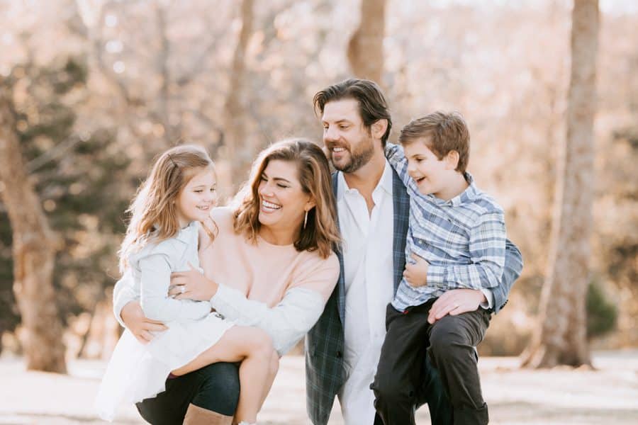 Family Photography Session With Parents Looking At Children Smiling