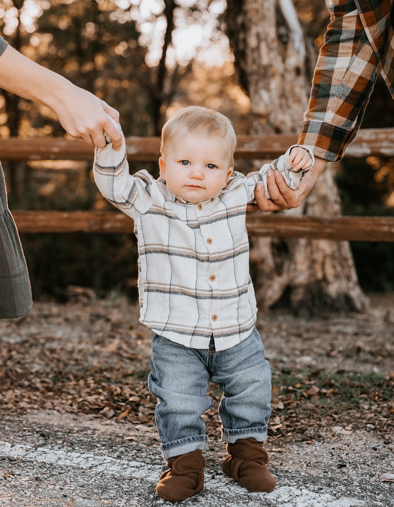 close up photo of baby while parents hold his hands for a rockwall family session portrait locations