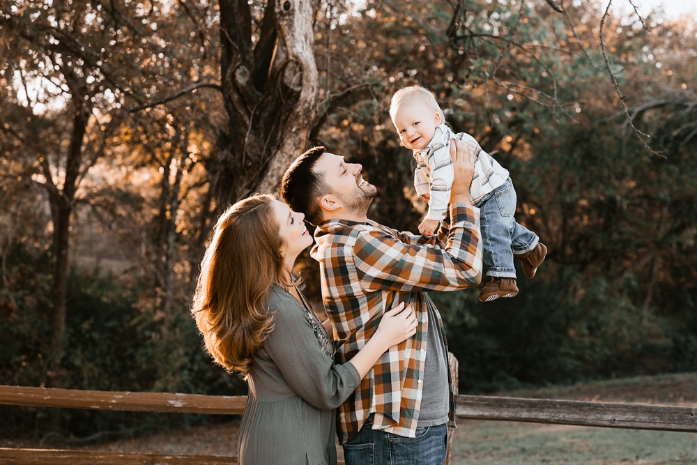 parents smiling with baby during a family photo session in dallas