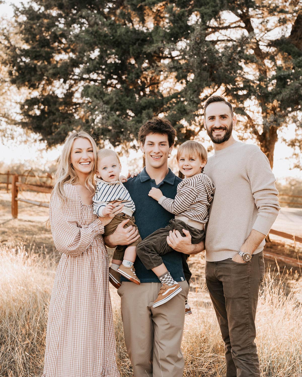 Smiling family of five during an outdoor golden hour session at a Dallas park captured by a Dallas family photography studio