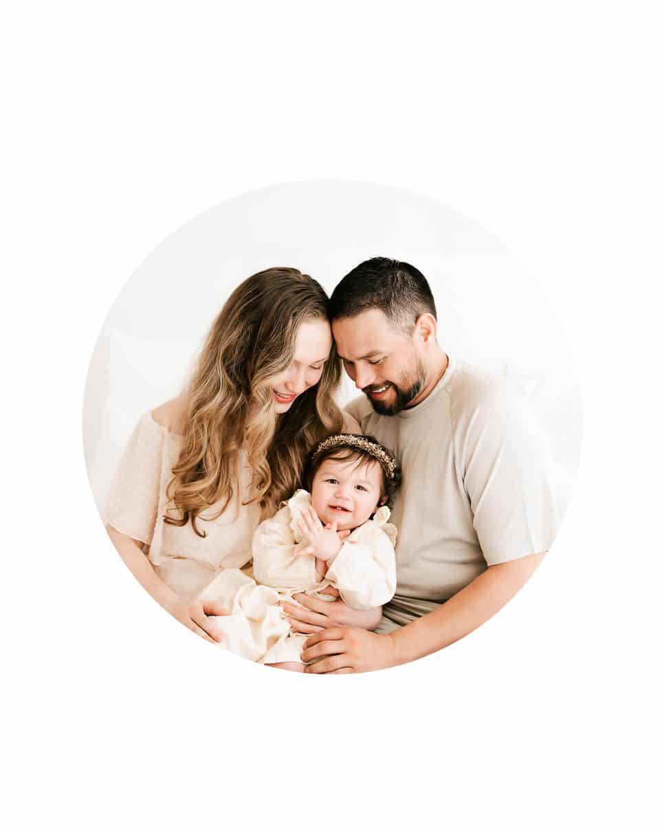 Lifestyle studio family photography session in Dallas featuring parents and baby in a soft neutral studio setting