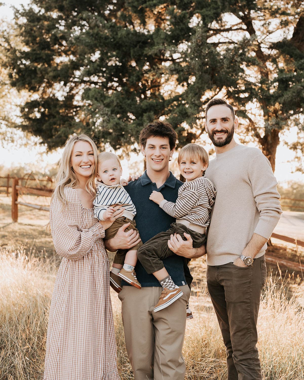 Outdoor golden hour family portrait by Dallas family photographer Lily Hayes in Rowlett, Texas featuring parents and young children in warm natural light