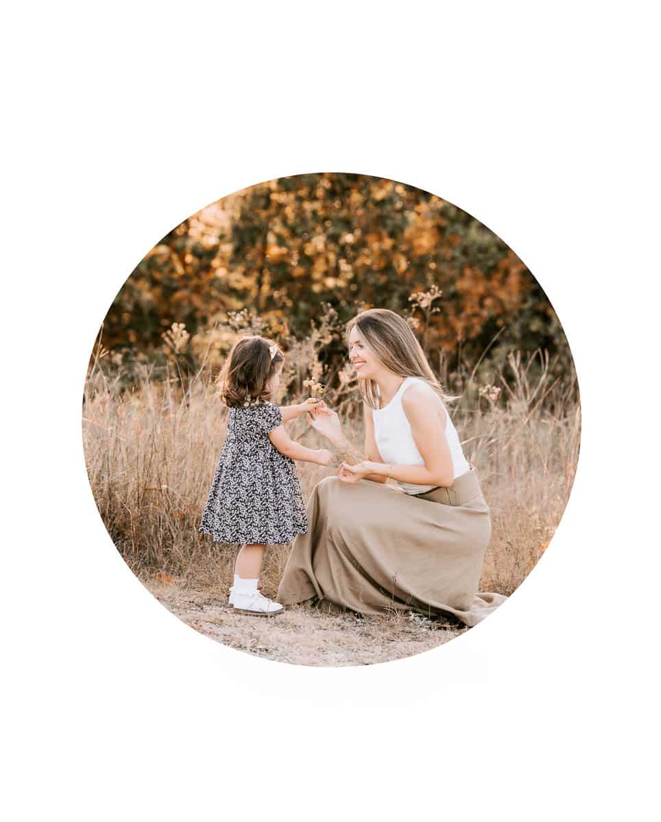 Mini outdoor family photoshoot in Dallas featuring mother and toddler during golden hour in a natural field setting